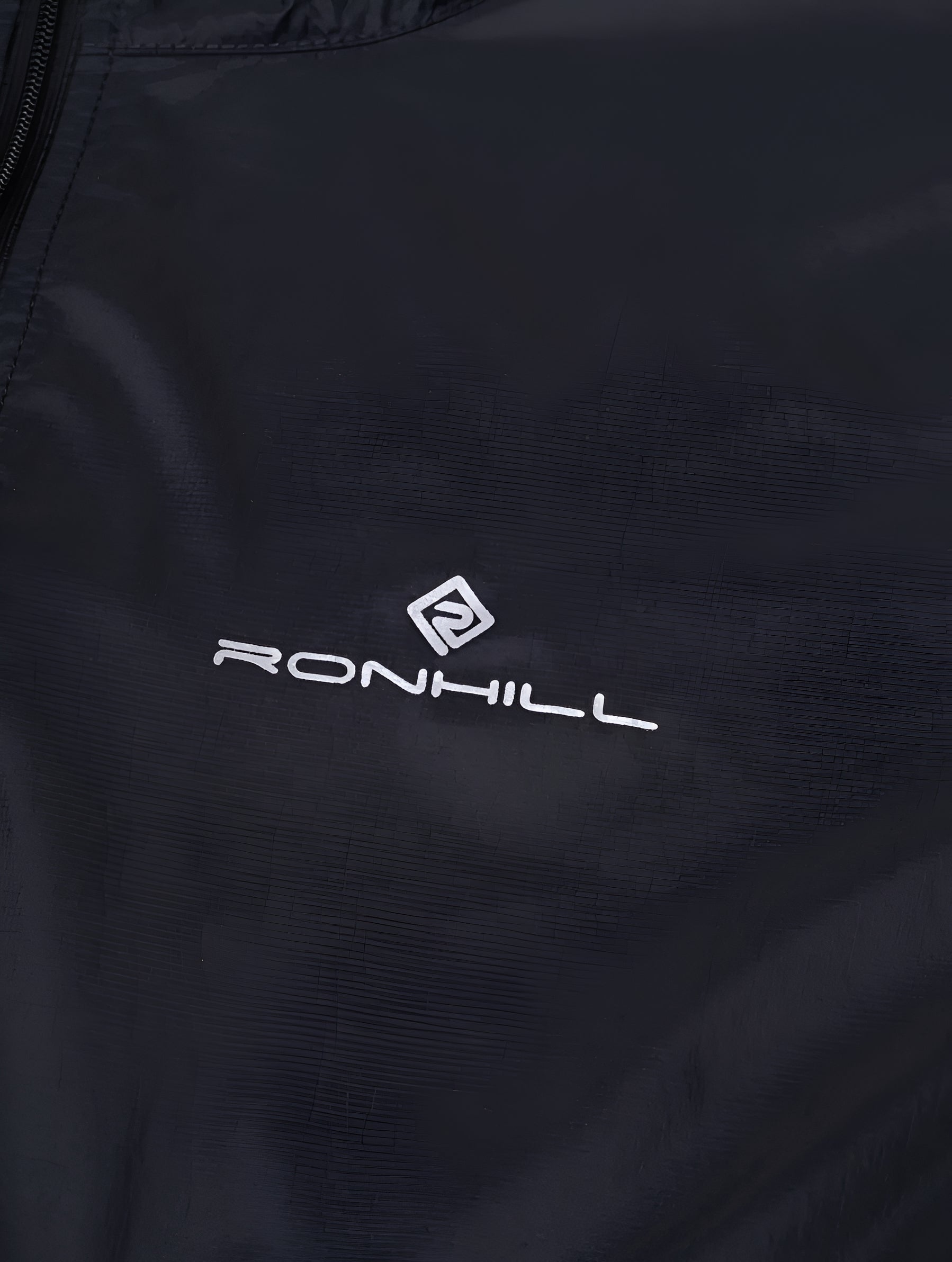 Ronhill Women's Tech All-Terrain Jacket in All Black - brand logo detail