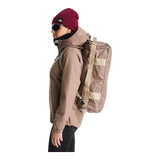 The North Face Base Camp Voyager Duffel 32L in Garnet/Timeless Taupe - worn, side profile