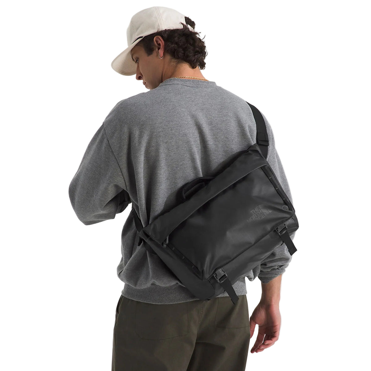 The North Face Base Camp Voyager Messenger Bag 12L being worn, demonstrating adjustable shoulder strap and comfortable carry