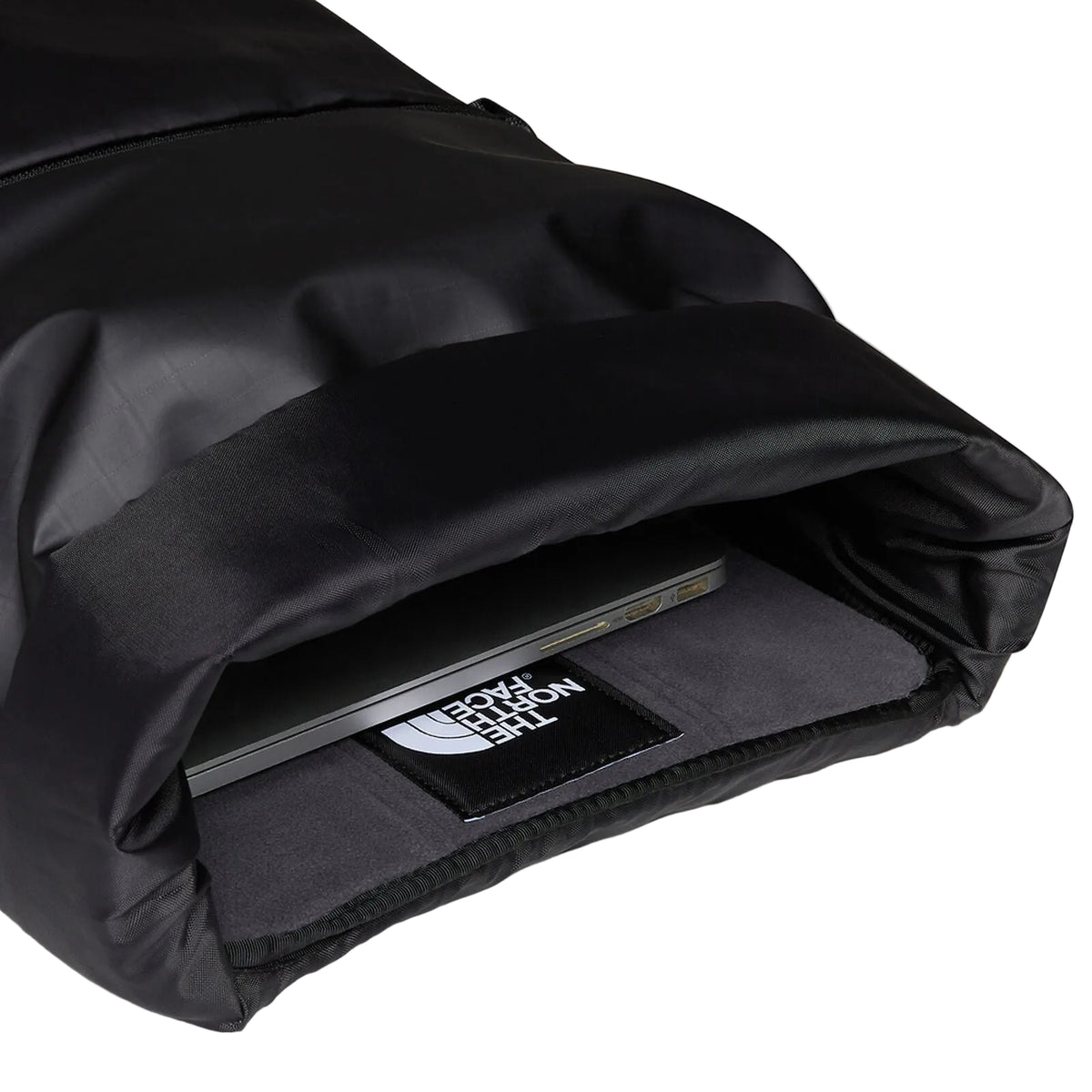 The North Face Base Camp Voyager Roll Top Backpack 25L being worn, demonstrating comfortable all-day carry