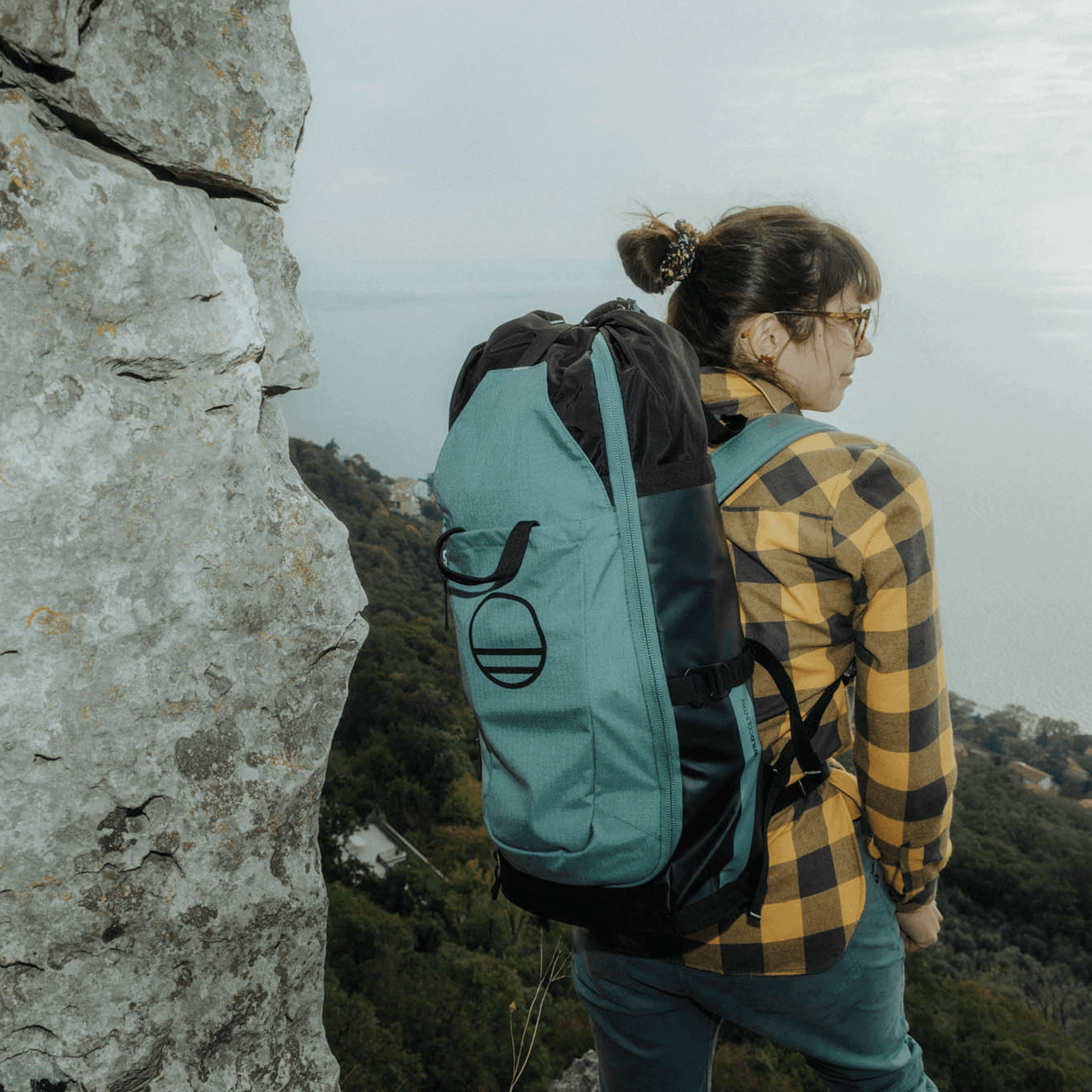 Wild Country Climbing Crag Hauler 25 Backpack Outdoor Action Black/Marsh - on models back up a mountain