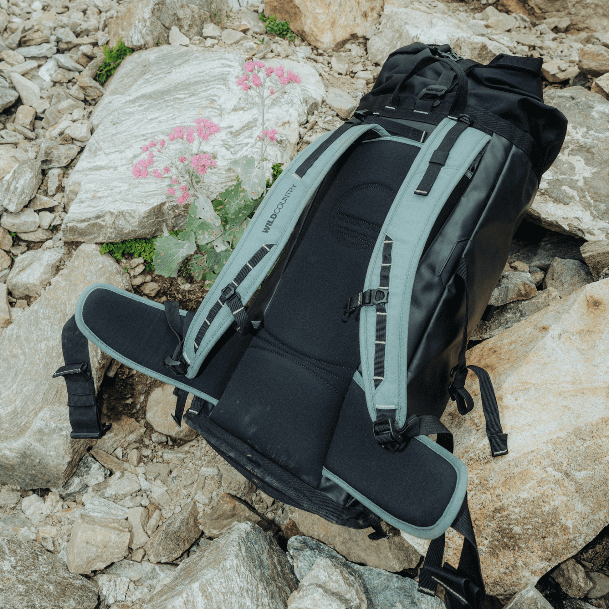 Wild Country Climbing Crag Hauler 40 Backpack Outdoor Action Black/Marsh - pack laying on rock