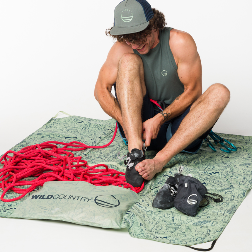 Wild Country Climbing Rope Tarp Model Sitting on Tarp With Rope Attached