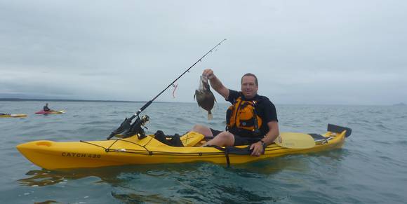 Mission CATCH 420 EXP kayak, Yellow kayak with an angler