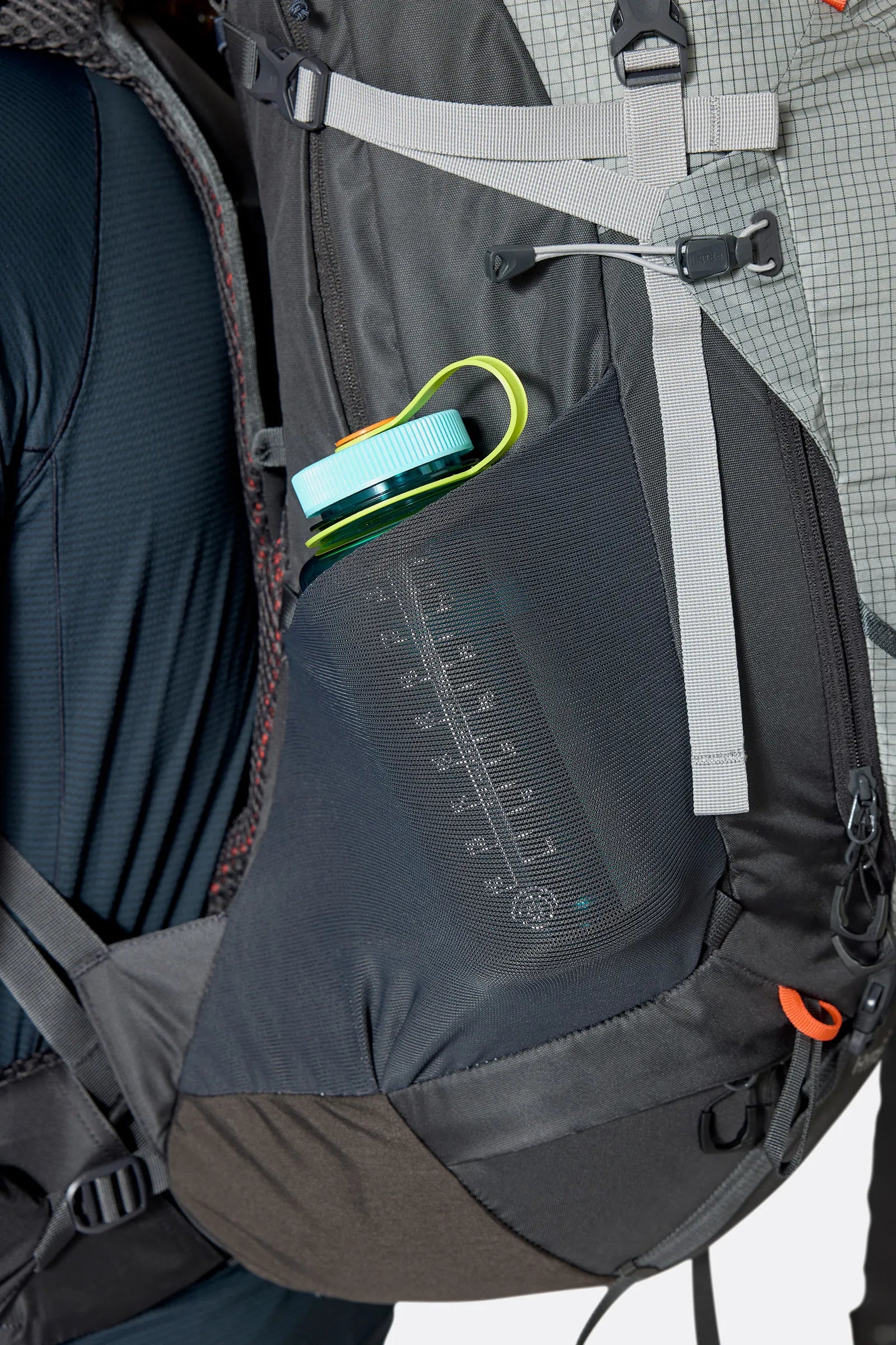 Rab Hyperon 65L Trekking Pack in Dark Pewter/Anthracite - side stretch pocket with water bottle, worn