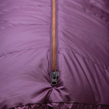 Mountain Equipment Classic Eco 300 Women's Sleeping Bag in Raisin with storage cube showing packable recycled down insulation