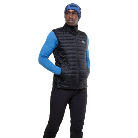 Mountain Equipment Frostline Men's Vest in Black worn on model - angled front view showing DRILITE Loft 20D shell and stitch-through narrow baffles