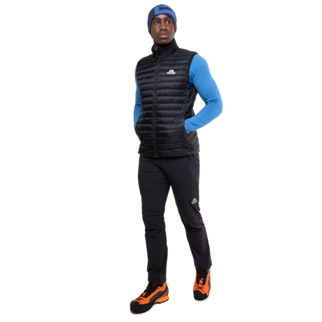 Mountain Equipment Frostline Men's Vest in Black worn on model - full length angled front view showing lightweight packable down vest for year-round layering