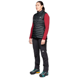 Mountain Equipment Frostline Women's Vest in Black worn on model - angled front view showing lightweight packable down vest for year-round layering