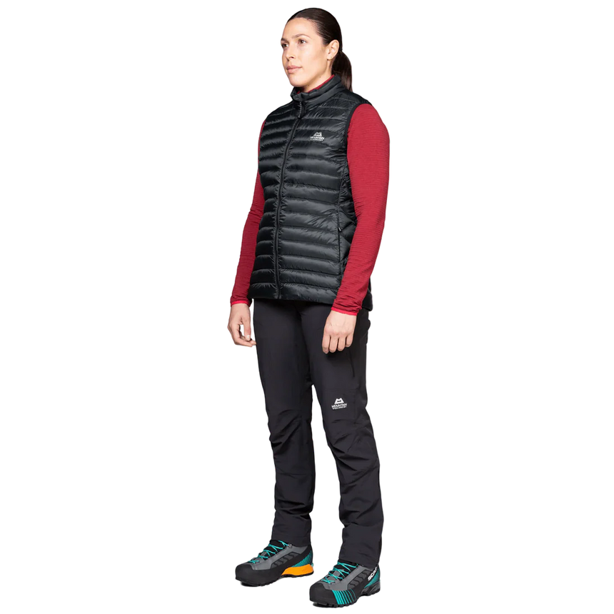 Mountain Equipment Frostline Women's Vest in Black worn on model - angled front view showing lightweight packable down vest for year-round layering