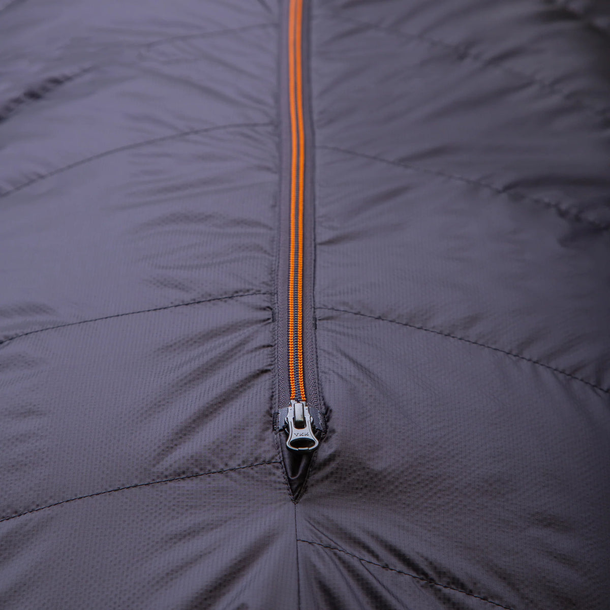 Mountain Equipment Glacier 300 Sleeping Bag in Obsidian packed into waterproof roll-top stuff sack