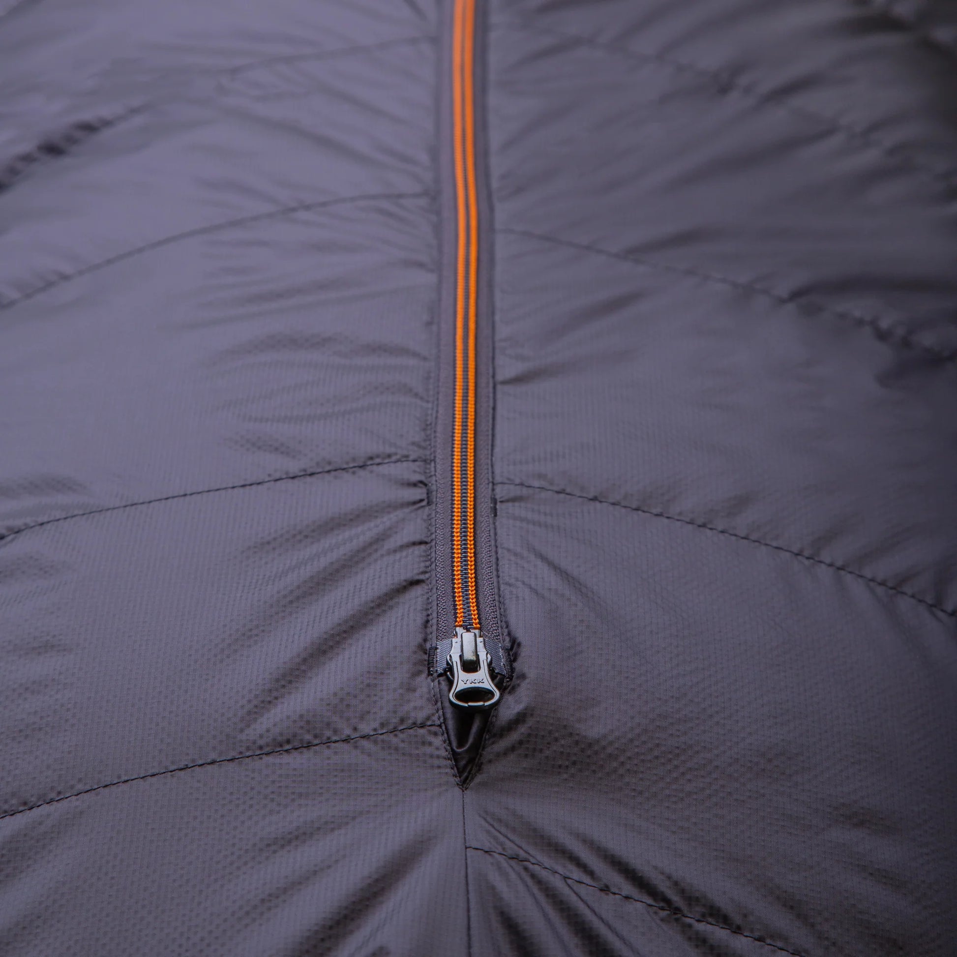 Mountain Equipment Glacier 300 Sleeping Bag in Obsidian packed into waterproof roll-top stuff sack
