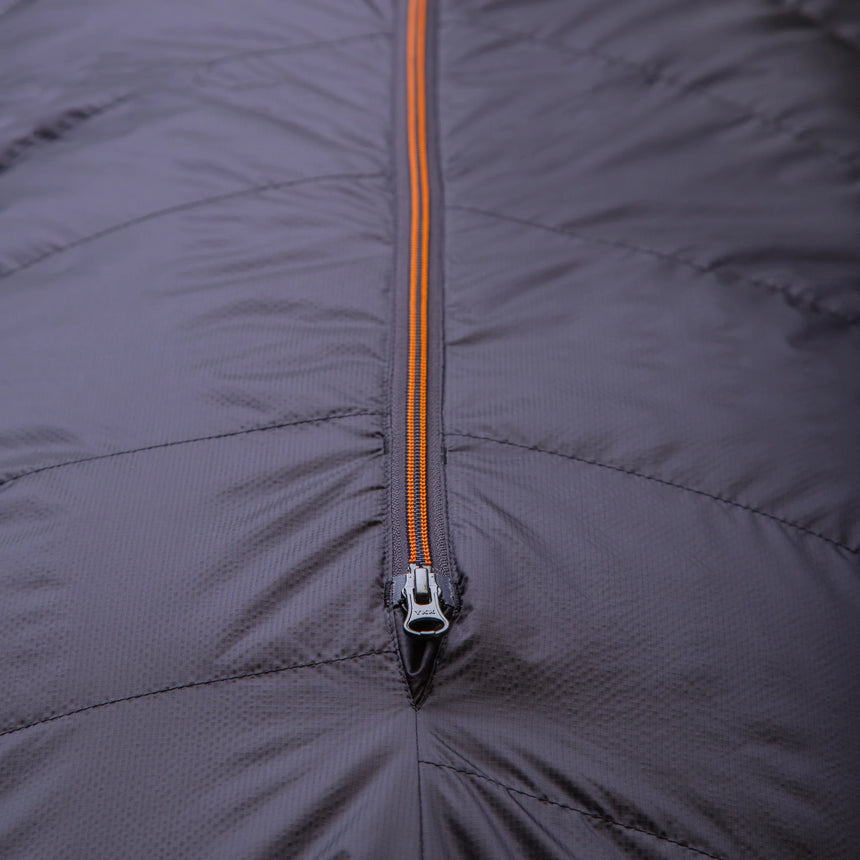 Mountain Equipment Glacier 300 Sleeping Bag in Obsidian packed into waterproof roll-top stuff sack