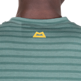 Mountain Equipment Groundup Men's Tee in Fern Stripe - lifestyle view showing fast-drying stretchy tee for mountain walking and trekking