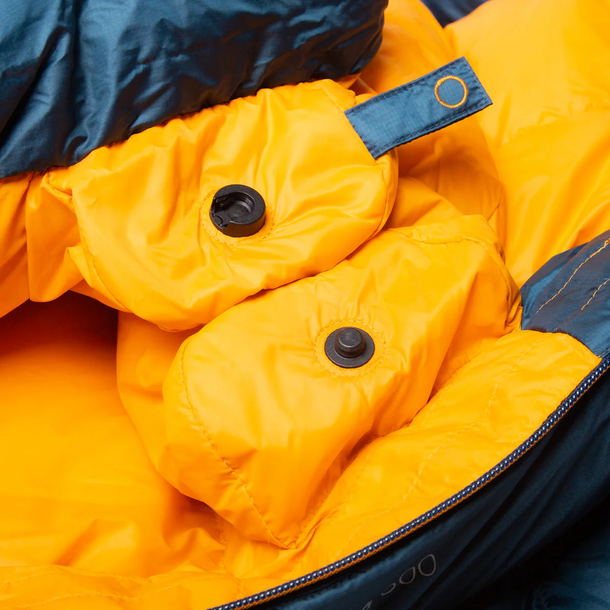 Mountain Equipment Helium 400 Sleeping Bag in Majolica Blue packed into waterproof roll-top stuff sack showing compact 24 x 21 x 20 cm packed size