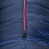 Mountain Equipment Helium 800 Women's Sleeping Bag in Medieval Blue packed into waterproof roll-top stuff sack showing compact 30 x 24 x 23 cm packed size