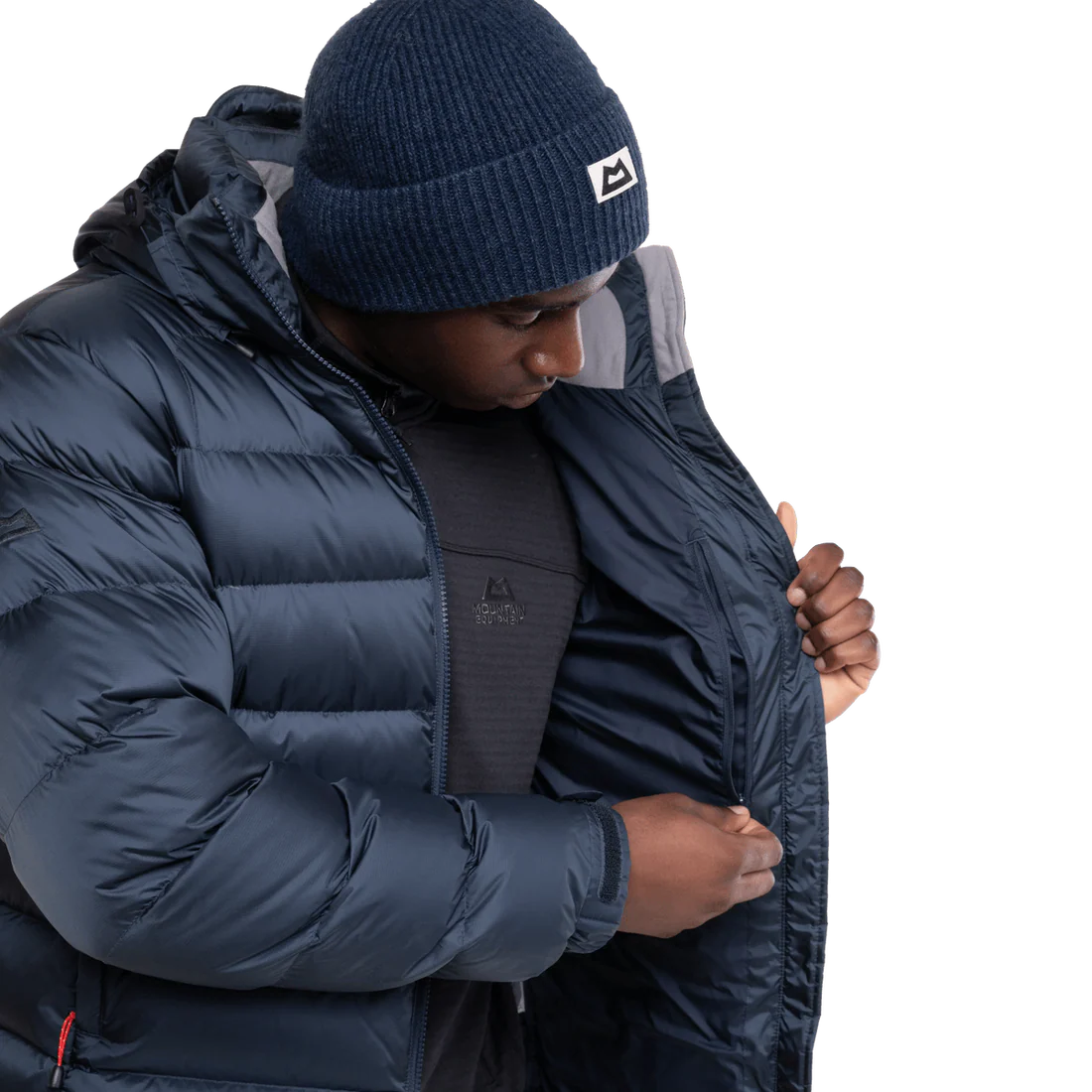 Mountain Equipment Lightline Men's Jacket in Blue Nights/Cosmos packed into stuff sack showing lightweight packable construction