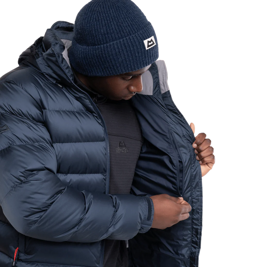 Mountain Equipment Lightline Men's Jacket in Blue Nights/Cosmos packed into stuff sack showing lightweight packable construction