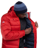 Mountain Equipment Lightline Men's Jacket in Chili Red packed into stuff sack showing lightweight packable construction