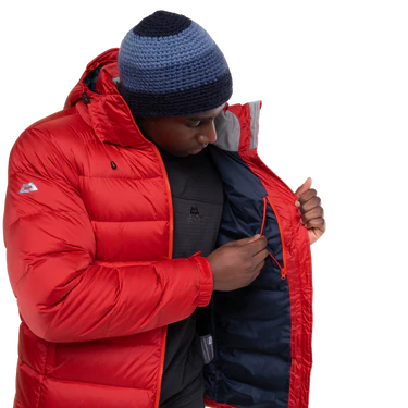 Mountain Equipment Lightline Men's Jacket in Chili Red packed into stuff sack showing lightweight packable construction