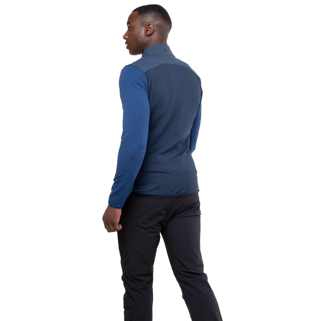 Mountain Equipment Switch Men's Vest in Dusk/Cosmos - lifestyle view showing hybrid insulated vest for alpine climbing and ski touring