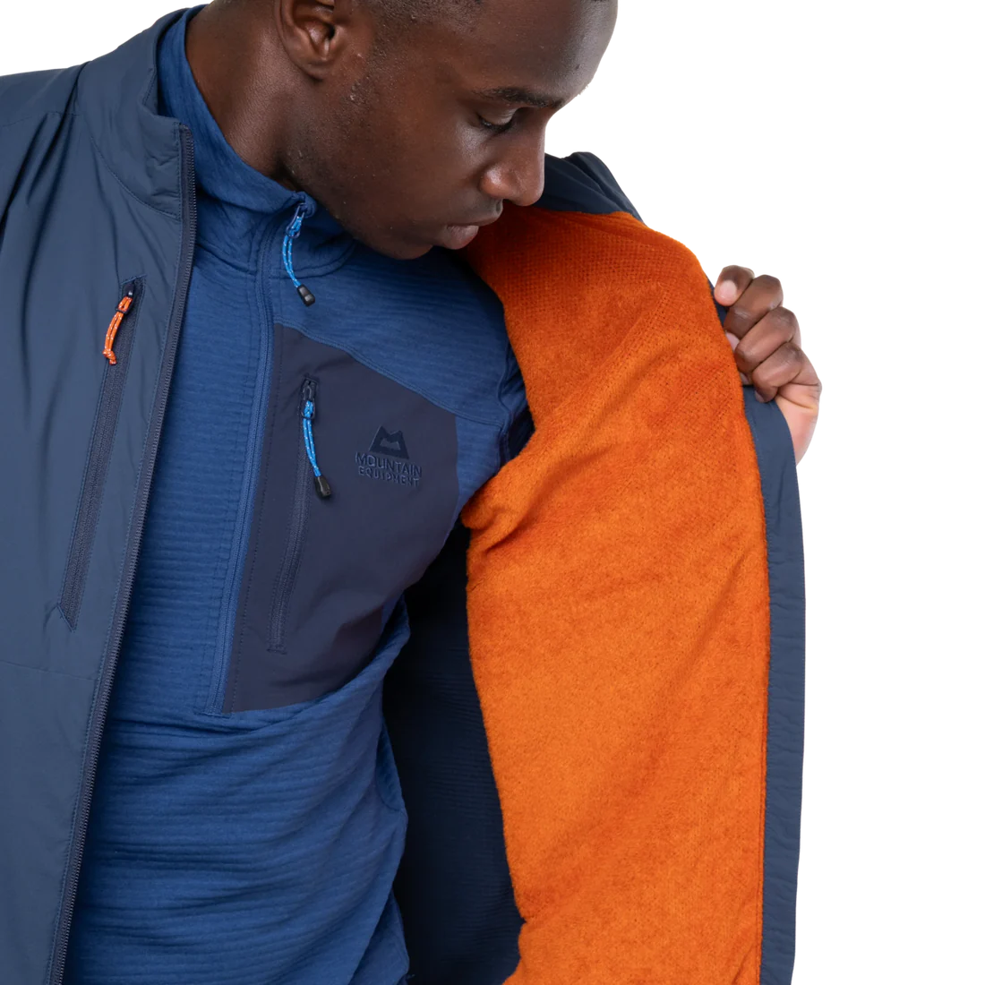 Mountain Equipment Switch Men's Vest in Dusk/Cosmos packed into hand pocket showing lightweight packable construction with twin carabiner carry loops