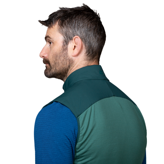 Mountain Equipment Switch Men's Vest in Pine/Fern - detail view showing zipped hand pocket positioned for use with a harness or rucksack waistbelt
