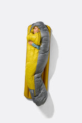 Rab Women's Neutrino Down Sleeping Bag in Zinc/Dark Pollen - worn seated