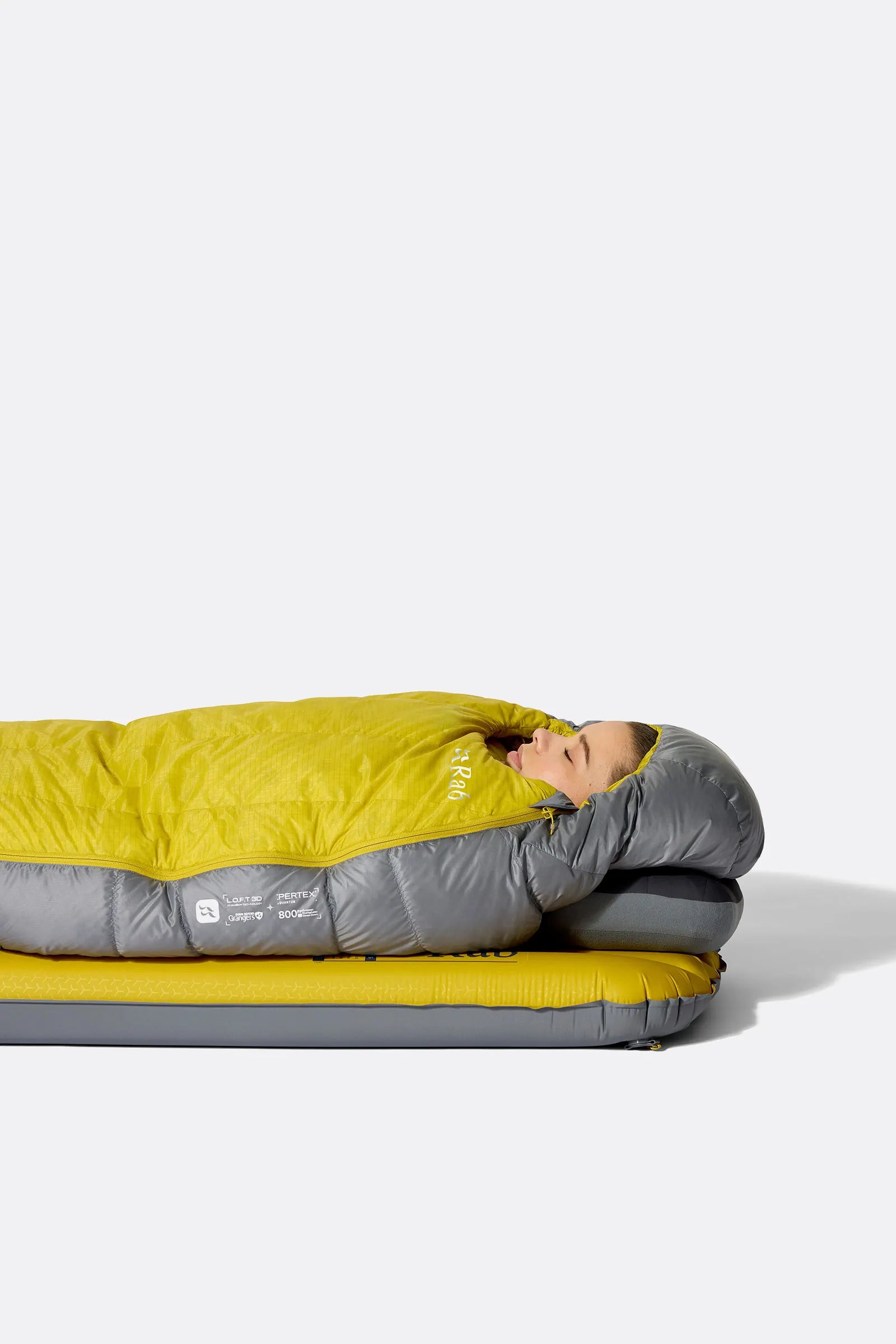 Rab Women's Neutrino Down Sleeping Bag in Zinc/Dark Pollen - worn side lying