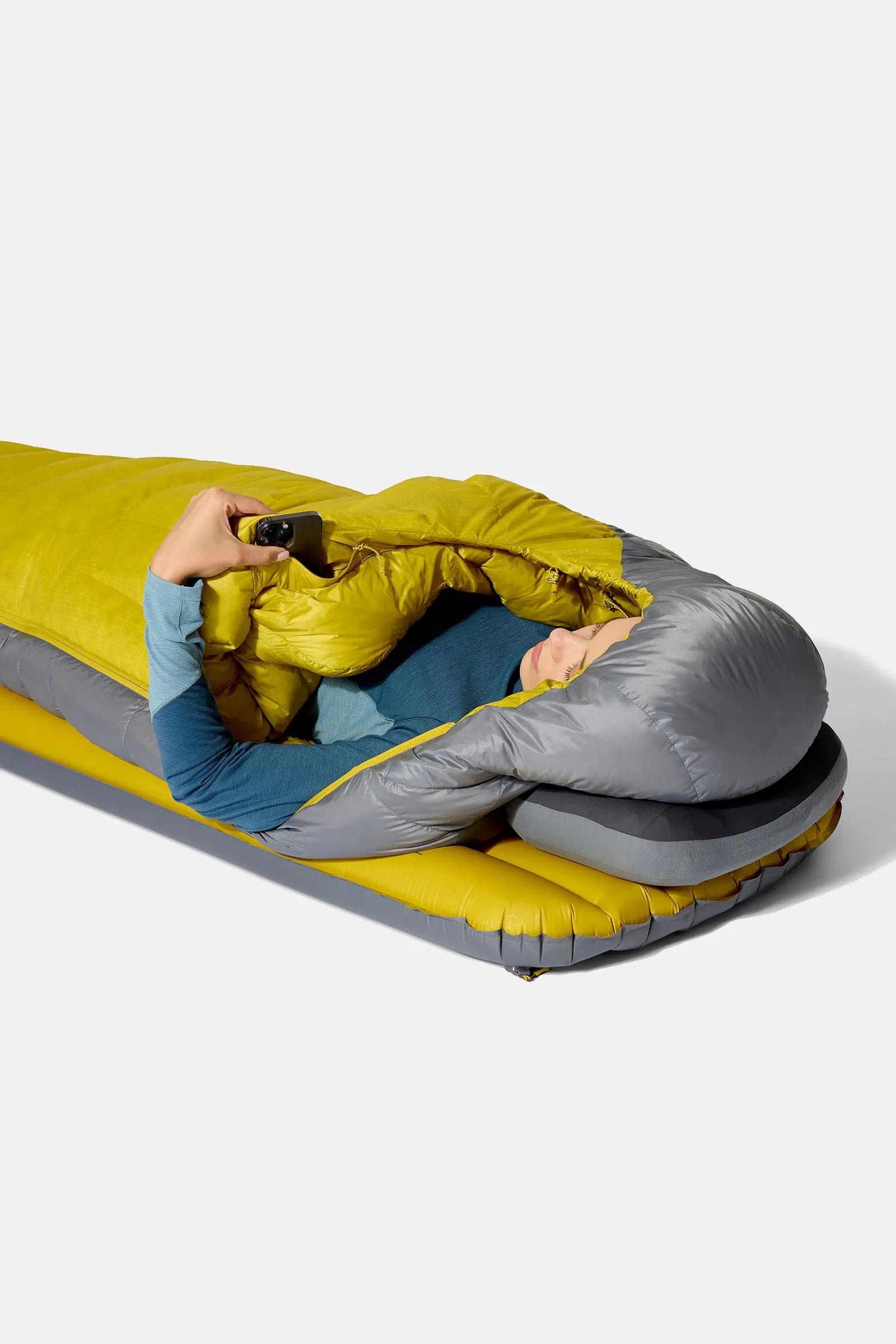 Rab Women's Neutrino Down Sleeping Bag in Zinc/Dark Pollen - worn overhead