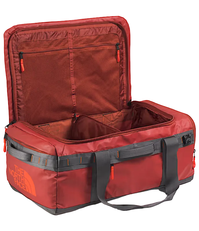 The North Face Base Camp Voyager Duffel 62L Iron Clay/Anthracite Grey/Lava Red - detail of daisy-chain webbing attachment points and recycled ballistic nylon boot construction