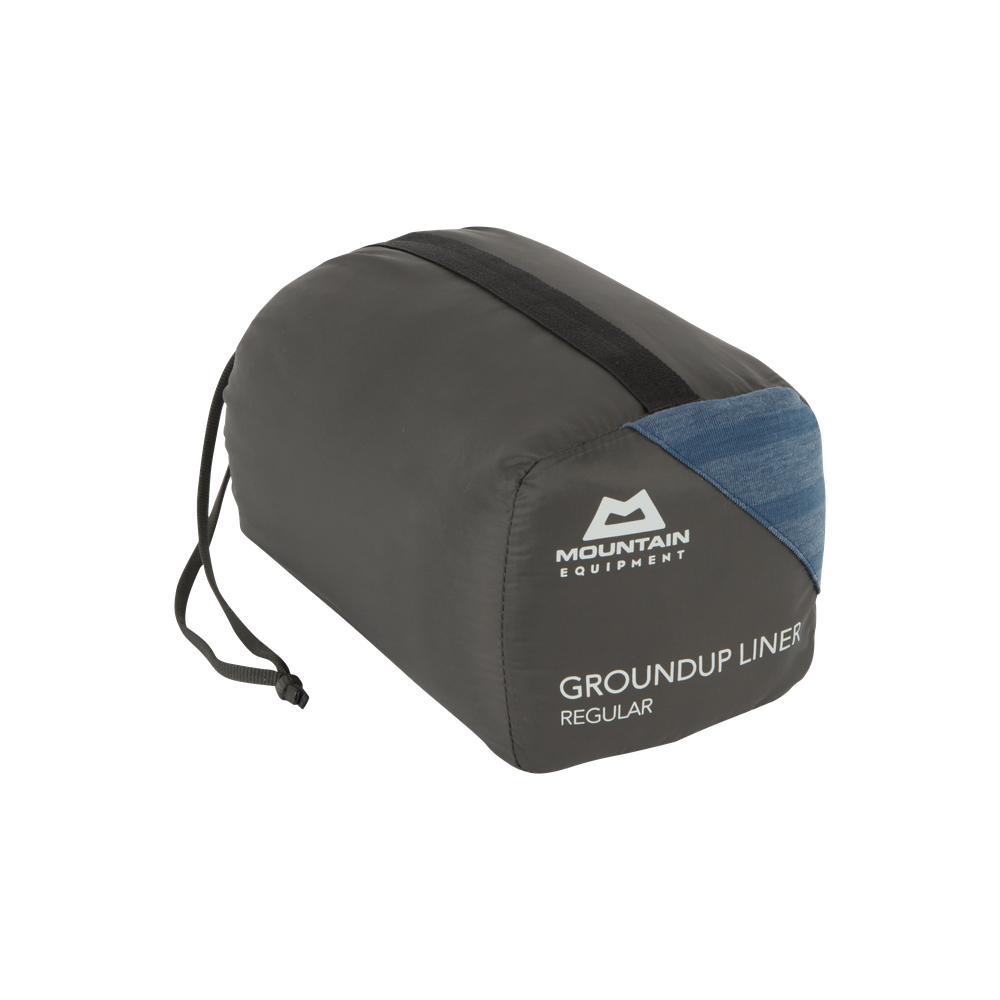 Mountain Equipment Groundup Mummy Sleeping Bag Liner in Denim Blue Stripe in stuff sack showing lightweight packable construction