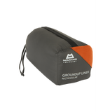 Mountain Equipment Groundup Rectangular Sleeping Bag Liner in Paprika in stuff sack showing lightweight packable construction