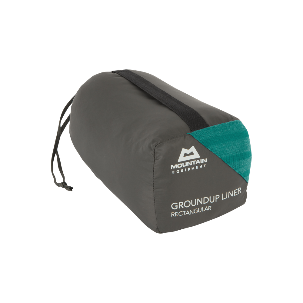 Mountain Equipment Groundup Rectangular Sleeping Bag Liner in Spruce Stripe in stuff sack showing lightweight packable construction